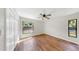 Bedroom with hardwood floors, ceiling fan, closet, and windows providing natural light at 501 Sportsman Park Dr, Seffner, FL 33584