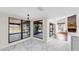 Bright dining area with marble floors, chandelier, and large windows to the backyard at 501 Sportsman Park Dr, Seffner, FL 33584