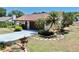 Attractive home with concrete driveway, mature palm trees, and decorative stone edging at 501 Sportsman Park Dr, Seffner, FL 33584