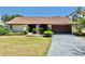 Charming home with a well-kept lawn and mature landscaping, with a two-car garage at 501 Sportsman Park Dr, Seffner, FL 33584