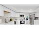 Renovated kitchen with white cabinets, stainless steel appliances, and ample counter space at 501 Sportsman Park Dr, Seffner, FL 33584