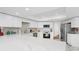 Modern kitchen with white cabinets, marble countertops, stainless steel appliances, and subway tile backsplash at 501 Sportsman Park Dr, Seffner, FL 33584
