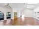 Spacious living room with wood floors, skylights, and large windows offering natural light at 501 Sportsman Park Dr, Seffner, FL 33584