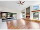 Bright living room with a fireplace and large windows overlooking the backyard at 501 Sportsman Park Dr, Seffner, FL 33584