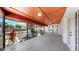 This screened patio features a terracotta ceiling and a clear view to the landscaped backyard at 501 Sportsman Park Dr, Seffner, FL 33584