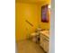 Accessible bathroom featuring yellow walls, tiled flooring, and safety handrails for convenience and safety at 5330 77Th N St, St Petersburg, FL 33709