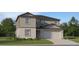 Charming two-story home showcasing a two-car garage, craftsman-style details, and a well-manicured front lawn at 5743 Yellow Hornbill Ave, Wimauma, FL 33598