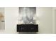 Stylish hallway decor features a dark cabinet with lamps and modern art at 5743 Yellow Hornbill Ave, Wimauma, FL 33598