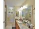 Well-lit bathroom featuring granite countertops, large mirror and walk-in shower at 601 Cedar Grove Dr, Brandon, FL 33511