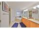 Bright bathroom featuring double sinks, a tub, and a separate shower at 601 Cedar Grove Dr, Brandon, FL 33511