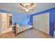 A blue bedroom features a bed, ceiling fan, and closet space at 601 Cedar Grove Dr, Brandon, FL 33511