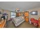 Cozy bedroom with carpet flooring, a ceiling fan, and a large window overlooking the yard at 601 Cedar Grove Dr, Brandon, FL 33511