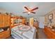 Comfortable bedroom with wooden built-ins, ceiling fan and carpeted floors at 601 Cedar Grove Dr, Brandon, FL 33511
