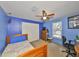 A bright bedroom with blue walls, a ceiling fan, and closet at 601 Cedar Grove Dr, Brandon, FL 33511