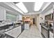 Bright kitchen with white cabinets, granite countertops, and an open layout to the living area at 601 Cedar Grove Dr, Brandon, FL 33511