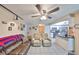 Open-concept living room showcasing tile flooring, ceiling fan, and a seamless transition to the kitchen at 601 Cedar Grove Dr, Brandon, FL 33511