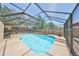 Enjoy a screened-in pool with clear blue water and paved area, perfect for relaxation at 601 Cedar Grove Dr, Brandon, FL 33511