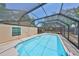 Enjoy a screened-in pool with clear blue water and paved area, perfect for relaxation at 601 Cedar Grove Dr, Brandon, FL 33511