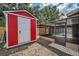 Backyard view of a red storage shed and screened pool area at 613 Valley Hill Dr, Brandon, FL 33510