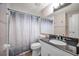 Bathroom featuring vanity with granite countertop, tiled shower, and modern fixtures at 613 Valley Hill Dr, Brandon, FL 33510