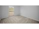 Bright bedroom with plush carpeting and a large window offering ample natural light at 613 Valley Hill Dr, Brandon, FL 33510
