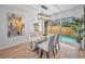 Charming dining room with a glass-top table, stylish chairs, and views of the pool at 613 Valley Hill Dr, Brandon, FL 33510