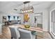 Bright dining area with a glass table and modern lighting, seamlessly flowing into the adjacent living room at 613 Valley Hill Dr, Brandon, FL 33510