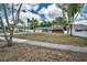 Two-story home with a two-car garage, complemented by mature trees, with a sidewalk leading to the property at 613 Valley Hill Dr, Brandon, FL 33510