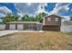 Charming two-story home with a two-car garage and a well-manicured front yard on a sunny day at 613 Valley Hill Dr, Brandon, FL 33510