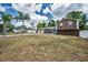 Two story house with a two car garage on a big lot, surrounded by lush greenery and vibrant blue skies at 613 Valley Hill Dr, Brandon, FL 33510