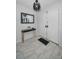 Bright foyer featuring a modern light fixture, console table, and tiled flooring at 613 Valley Hill Dr, Brandon, FL 33510