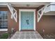 Close-up of a stylish light-blue double front door with decorative tile entryway at 613 Valley Hill Dr, Brandon, FL 33510
