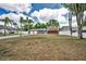 Charming two-story home with a spacious front yard, palm trees, and three-car garage at 613 Valley Hill Dr, Brandon, FL 33510