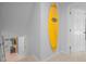 Hallway with surfboard wall decor and neutral carpeting leading to bedroom at 613 Valley Hill Dr, Brandon, FL 33510