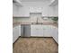 Well-lit kitchen with stainless steel appliances, white cabinets, granite countertops and mosaic backsplash at 613 Valley Hill Dr, Brandon, FL 33510