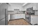 Well-lit kitchen with stainless steel appliances, white cabinets, granite countertops and mosaic backsplash at 613 Valley Hill Dr, Brandon, FL 33510