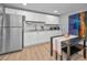 Well-lit kitchen featuring white cabinets, granite countertops, and stainless steel appliances at 613 Valley Hill Dr, Brandon, FL 33510