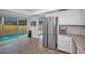 Kitchen featuring stainless appliances, white cabinets, and a view of the pool at 613 Valley Hill Dr, Brandon, FL 33510