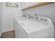 Convenient laundry room with white washer and dryer, complemented by shiplap wall at 613 Valley Hill Dr, Brandon, FL 33510