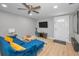 Comfortable living room area with a TV, ceiling fan, and luxury vinyl flooring at 613 Valley Hill Dr, Brandon, FL 33510