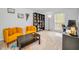Inviting living room with bright yellow seating and a dedicated workspace area at 613 Valley Hill Dr, Brandon, FL 33510