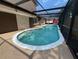 Beautiful in-ground pool with tiled accents, patio, and enclosed screen at 613 Valley Hill Dr, Brandon, FL 33510