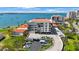 Aerial view of condos with a bay view featuring boat docks, and palm trees around parking and landscaping at 6357 Bahia Del Mar Blvd # 111, St Petersburg, FL 33715