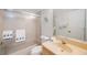 The bathroom features a combination tub and shower, with a neutral vanity and nautical-themed towels at 6357 Bahia Del Mar Blvd # 111, St Petersburg, FL 33715