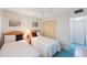 Bright bedroom features twin beds, ceiling fan, closet and carpet flooring at 6357 Bahia Del Mar Blvd # 111, St Petersburg, FL 33715