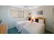 This cozy bedroom offers twin beds, a ceiling fan, and sun-filled natural light at 6357 Bahia Del Mar Blvd # 111, St Petersburg, FL 33715