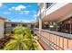 Condo with balconies and patios surround a courtyard of palm trees, bushes and flowering plants on a sunny day at 6357 Bahia Del Mar Blvd # 111, St Petersburg, FL 33715