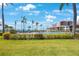 Beautifully landscaped grounds with pool, palm trees and bay views beyond at 6357 Bahia Del Mar Blvd # 111, St Petersburg, FL 33715