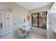 Bright kitchenette with a table for two, a window view, and white appliances at 6357 Bahia Del Mar Blvd # 111, St Petersburg, FL 33715