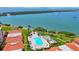 Aerial shot of pool area with lounge seating, covered areas, and views of the bay at 6357 Bahia Del Mar Blvd # 111, St Petersburg, FL 33715